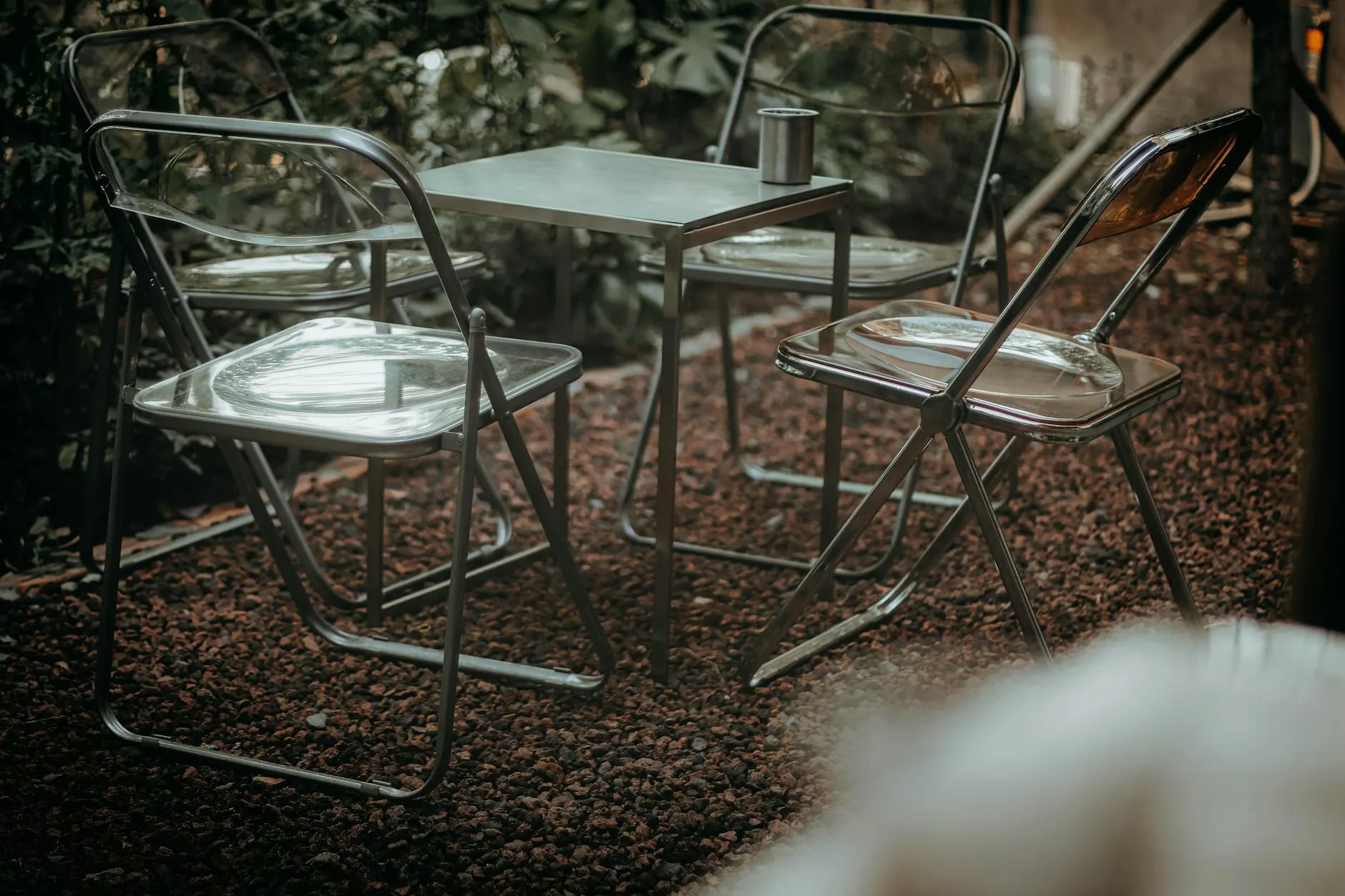 Four-seater patio dining set with chairs in a garden