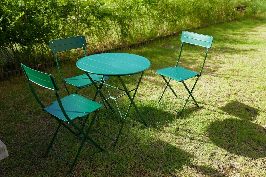 Garden dining furniture set on a patio surrounded by plants