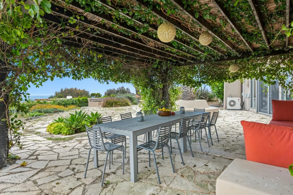 Stone patio with garden furniture in a UK garden