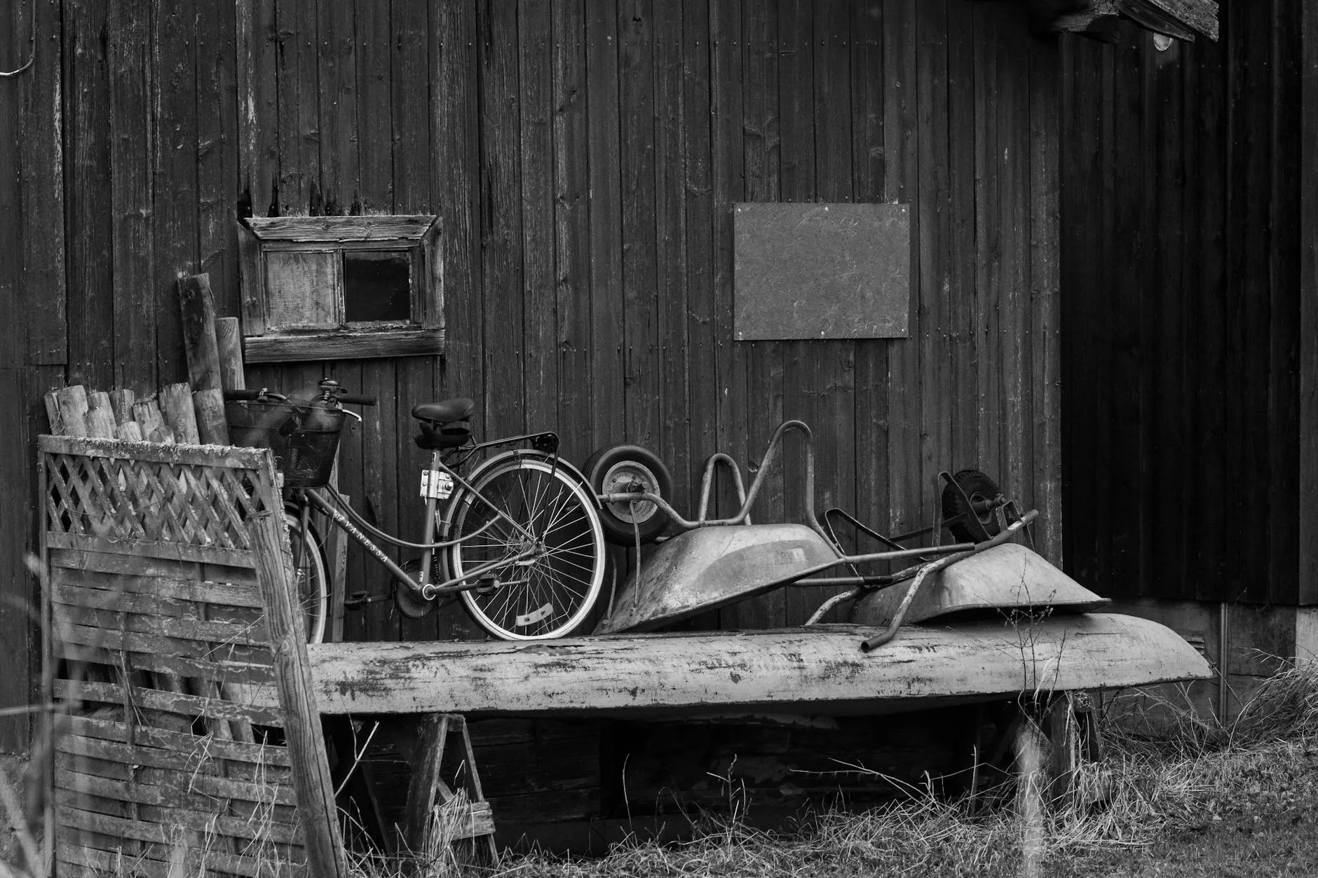 Garden tools and wheelbarrow stored neatly in a shed