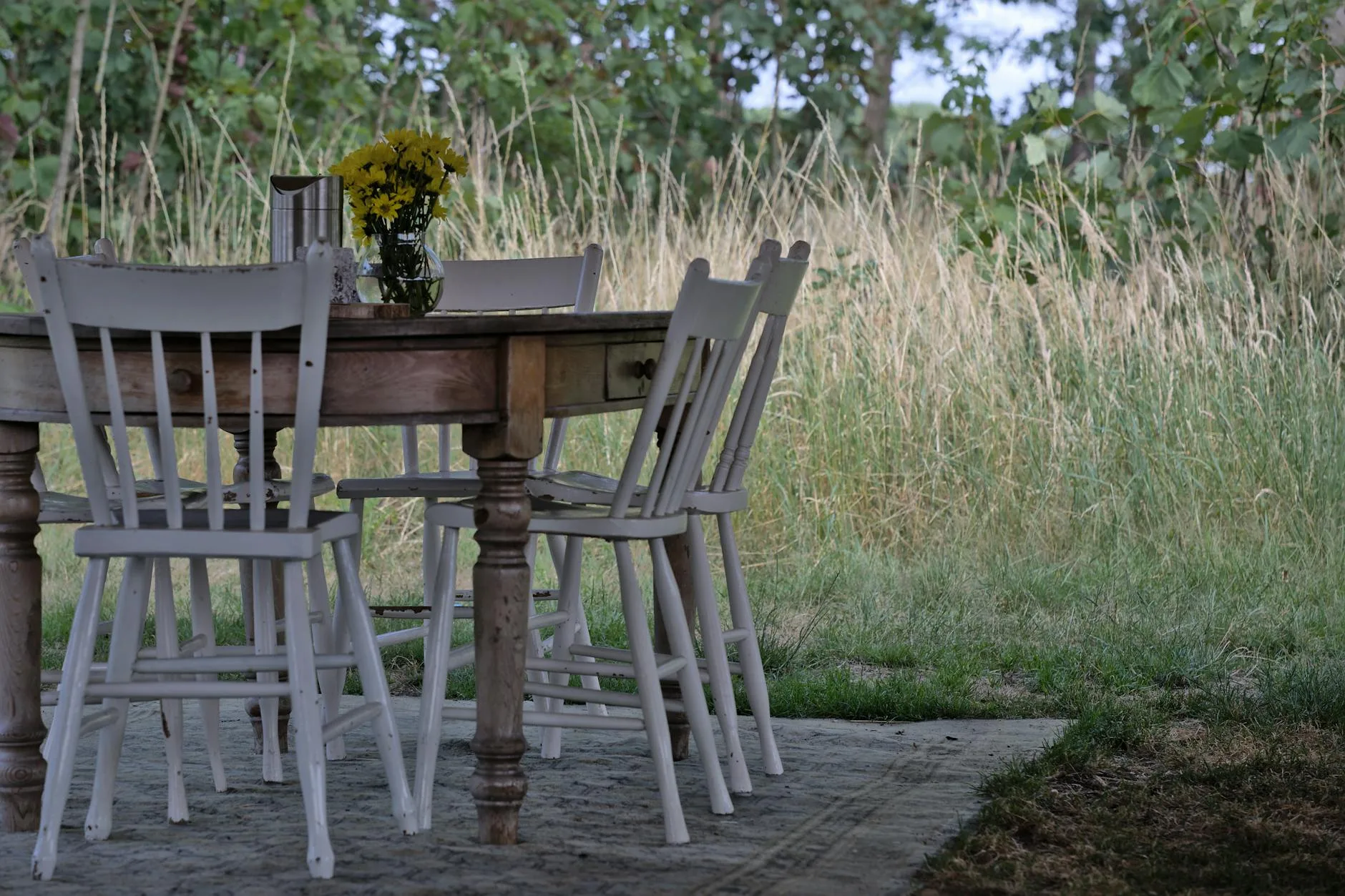 Outdoor dining set with table and chairs in a summer garden