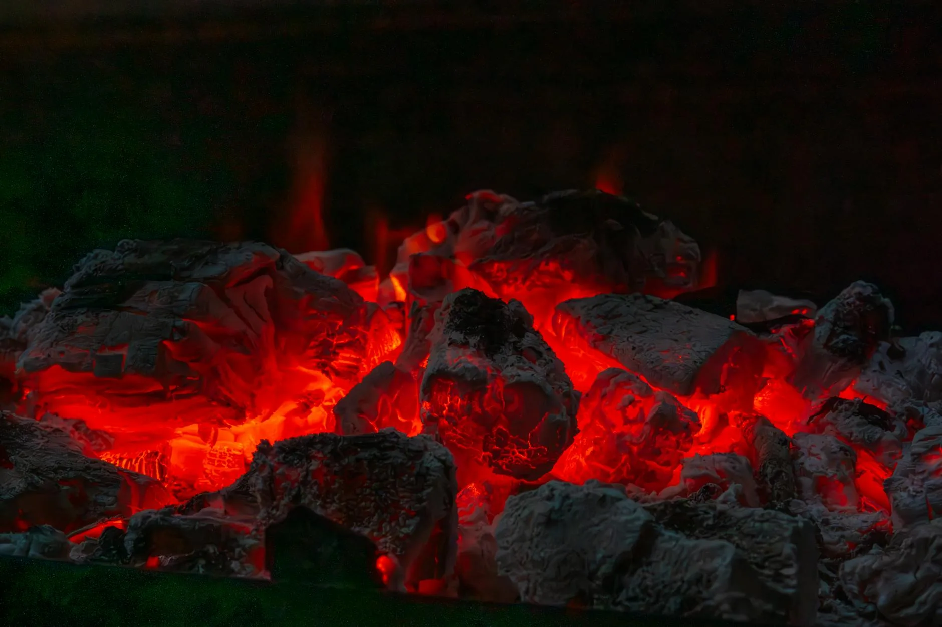 Glowing charcoal embers in a barbecue