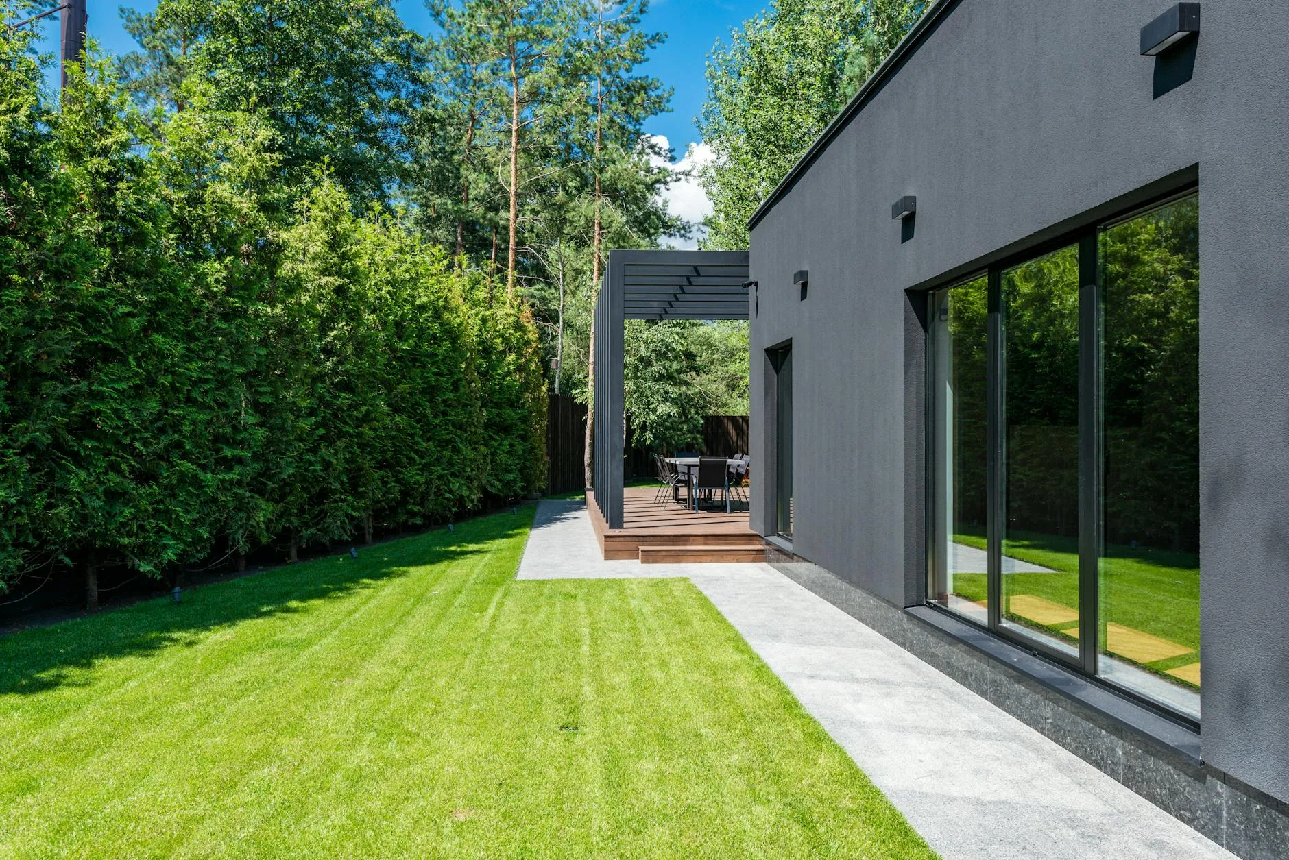 Sunny UK garden with patio decking and a green lawn