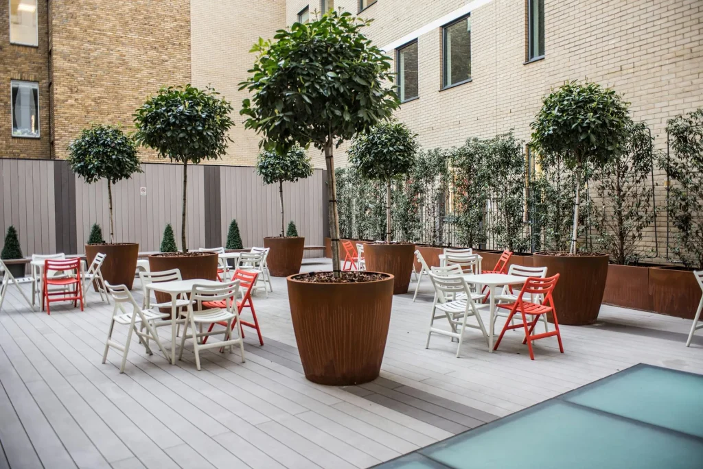 Large outdoor planters beside patio garden seating