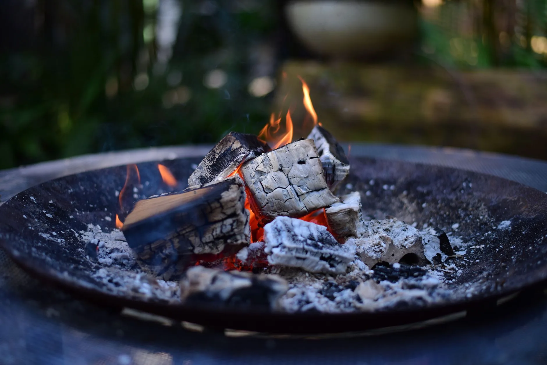 Fire pit embers cooling safely after use in a garden