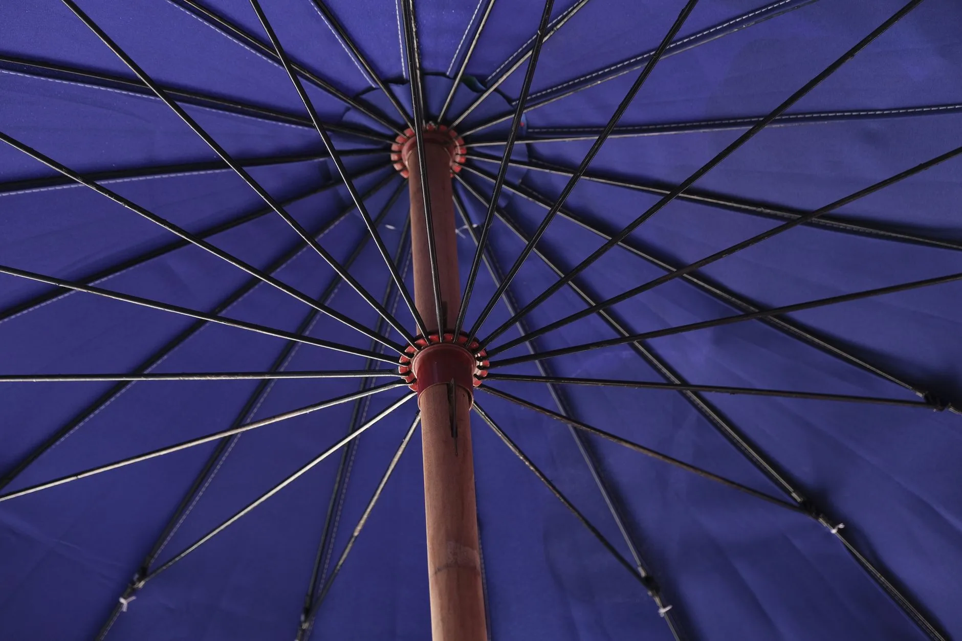 Garden parasol shading a patio dining set in a UK-style garden
