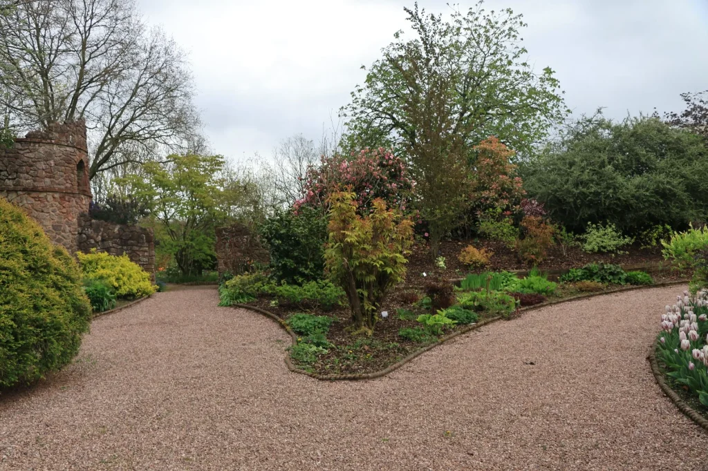 Garden path materials with gravel and paving through a UK garden