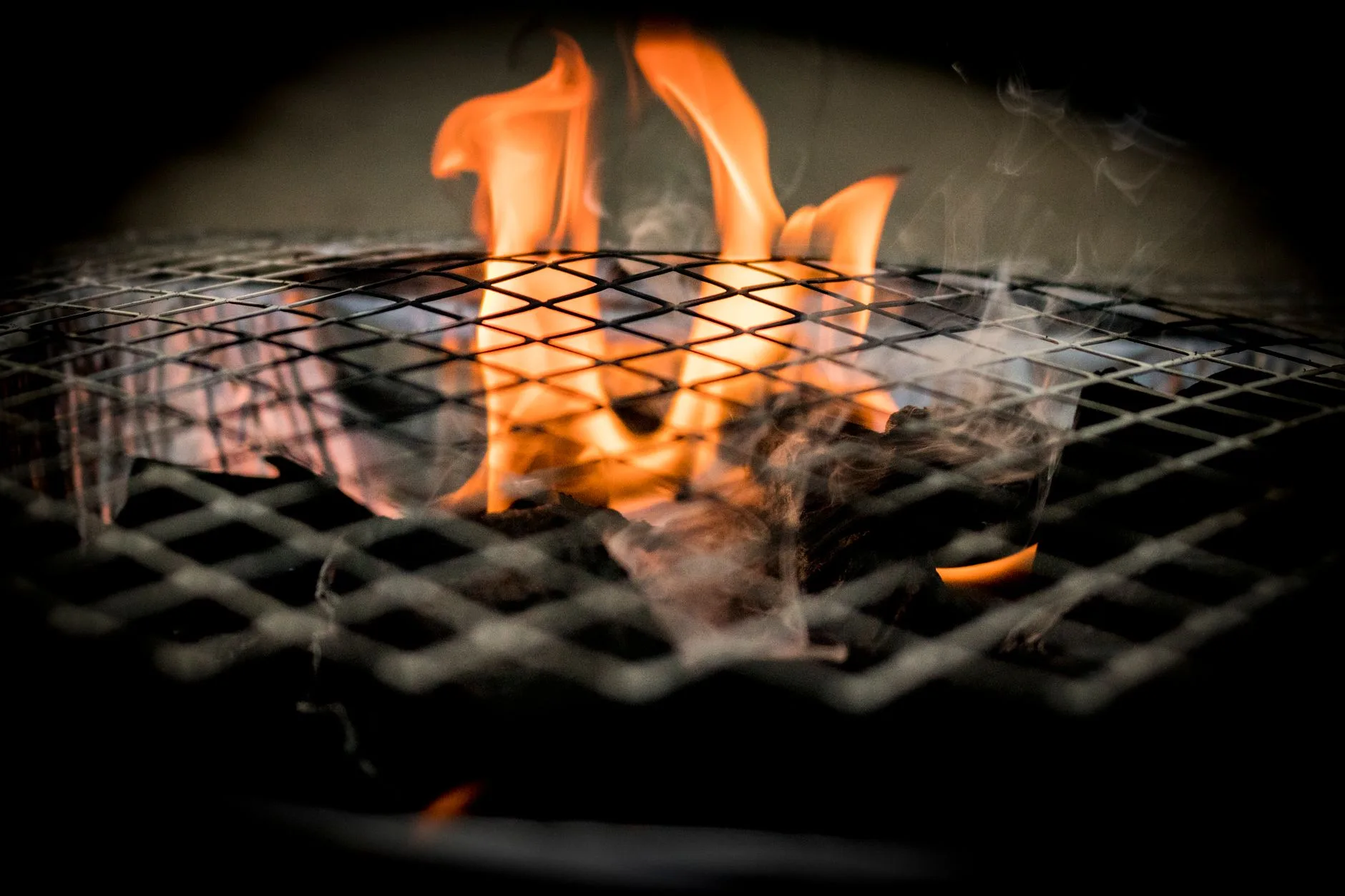 Ceramic kamado barbecue cooking over charcoal