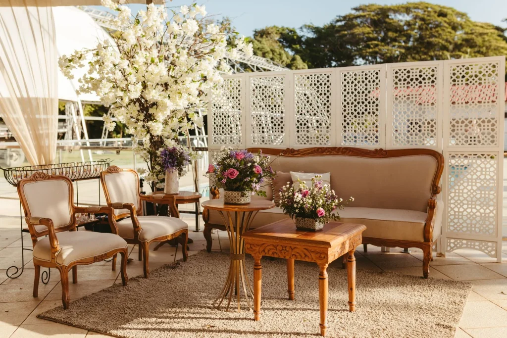 Outdoor rug beneath garden sofa seating on a paved patio