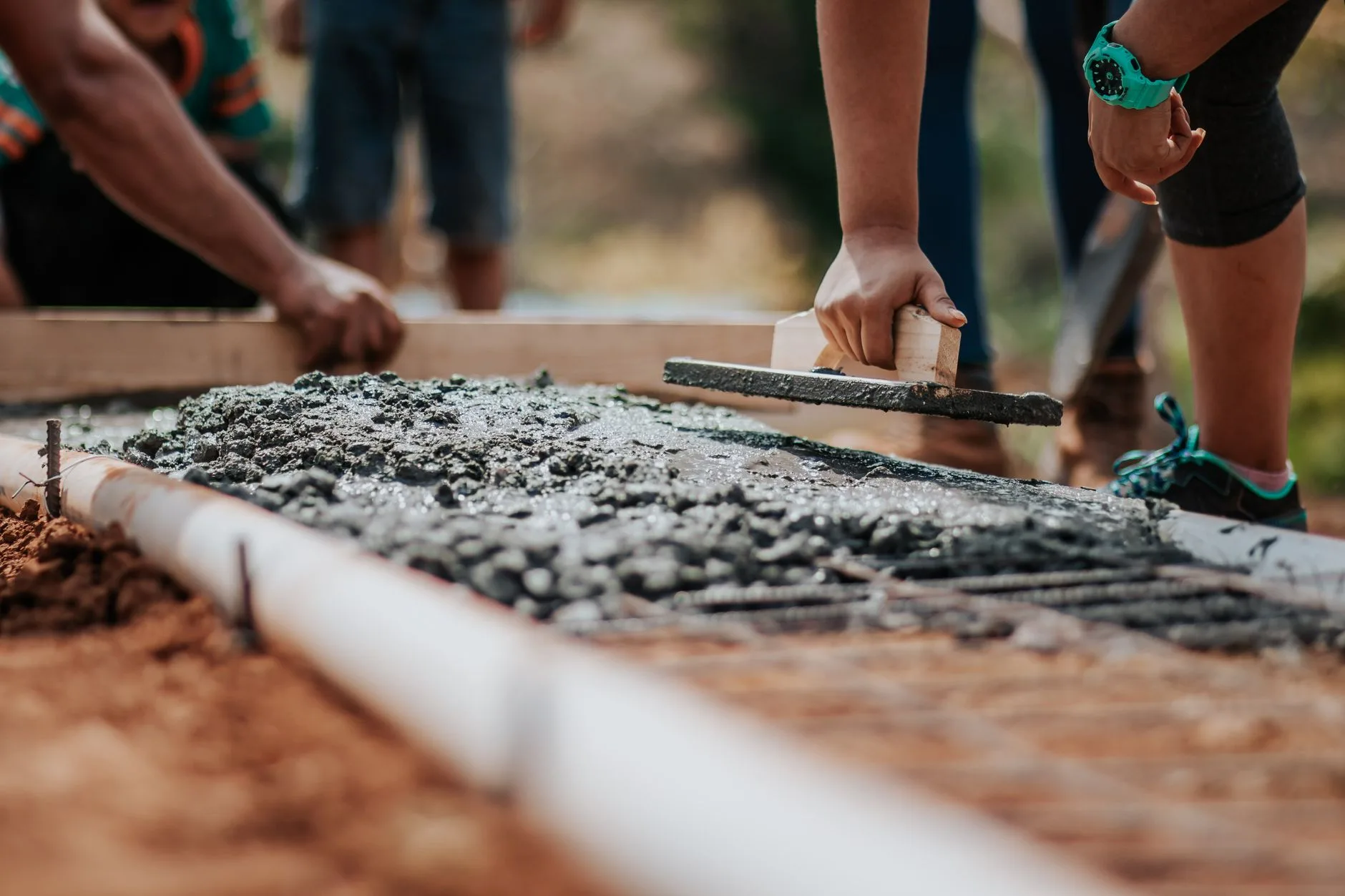 Workers laying paving slabs for a garden patio