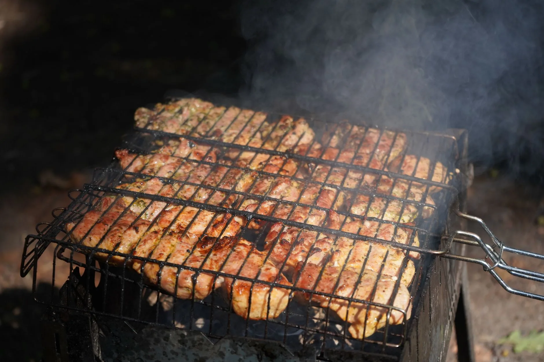 Charcoal kettle barbecue cooking grate on a garden patio