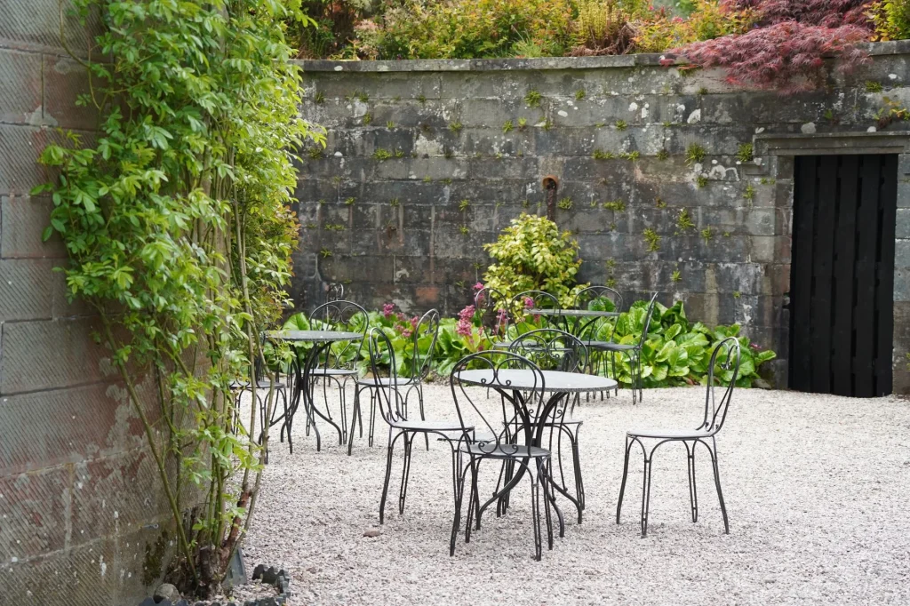 Small UK garden with patio seating and layered planting